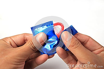 Man's Hands Unwrapping a Condom Stock Photo