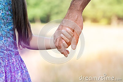 Man`s and kid`s hands. Father leads his child, summer nature outdoor. Parenting, togetherness, help, union, childhood, trust, Stock Photo