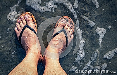 The man`s legs were wearing slippers, standing in a dirty flood Stock Photo