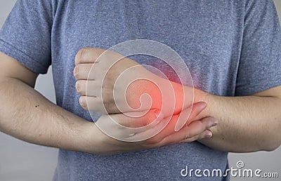 A man suffers from elbow pain. Damaged elbow joint, bone fracture, or sprain. Hand injury and flexion pain concept Stock Photo