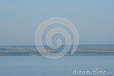 A man sails on a sup on a lake on a clear Sunny summer day Stock Photo
