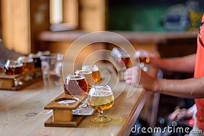 Beer flights lined up on a table at a microbrewery Stock Photo