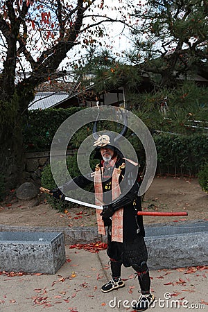 Man in Samurai Dress, Tourist Can be take a photo to keep a memorial at Himeji Castle. Editorial Stock Photo