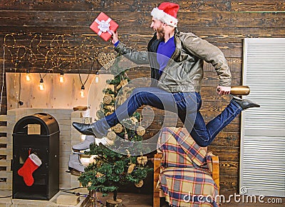 Man santa hat hurry to deliver gift on time. Christmas is coming. Spread happiness and joy. Bearded guy in motion jump Stock Photo