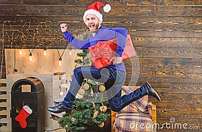 Man santa hat hurry to deliver gift on time. Spread happiness and joy. Bearded guy in motion jump. Delivery christmas Stock Photo
