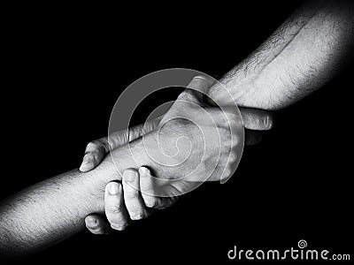 Man saving, rescuing and helping woman by holding or griping the forearm. Stock Photo