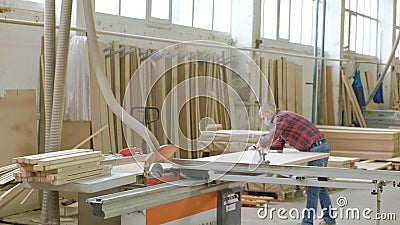 A Man Saws Wooden Door Blanks On The Machine The Production Of Village Interior Doors Plank Carpentry