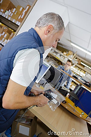 Man scanning producto with handheld device Stock Photo