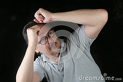 Man scared protecting his face with the arms Stock Photo