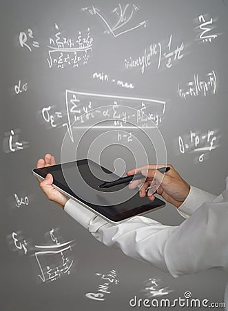 Man scientist or student holding tablet PC and working with various high school maths and science formulas. Stock Photo