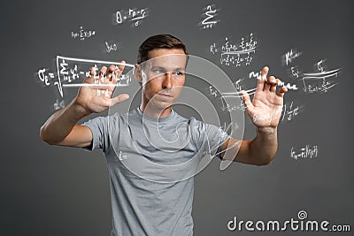 Man scientist or student working with various high school maths and science formulas. Stock Photo