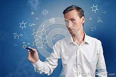 Man scientist with stylus or pen working with chemical formulas on blue background. Stock Photo