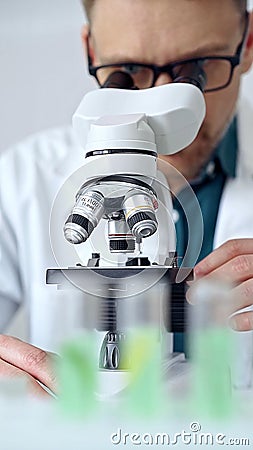 Man scientist using microscope in laboratory. Microbiology science concept Stock Photo