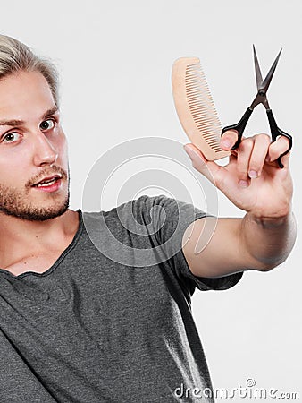 Man with scissors and comb creating new coiffure Stock Photo