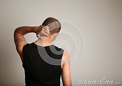 Man scratching back of head Stock Photo