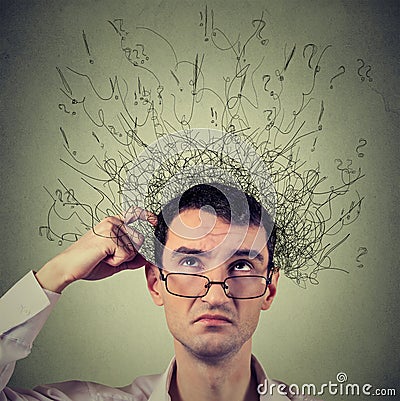 Man scratching head, thinking with brain melting into many lines question marks Stock Photo