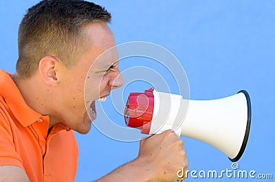 Man screaming through the megaphone Stock Photo