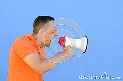 Man screaming through the megaphone Stock Photo