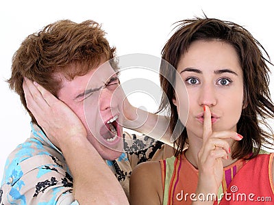 Man Screaming and Woman Making Silence Gesture Stock Photo