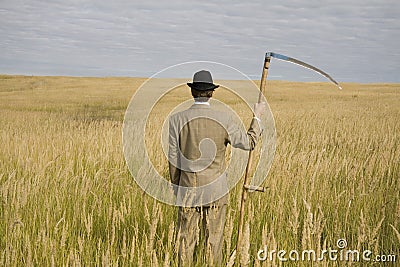 Man with scythe Stock Photo