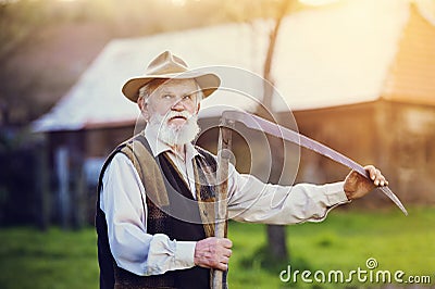 Man with scythe Stock Photo