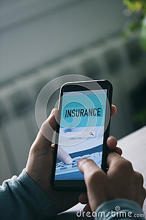 Man searching an insurance online Stock Photo