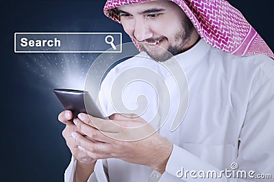 Man searching internet on mobile phone Stock Photo