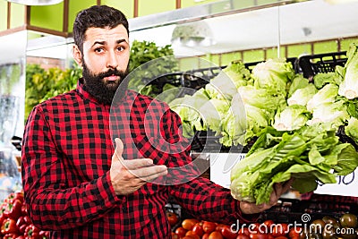 Man seller showing salad Stock Photo