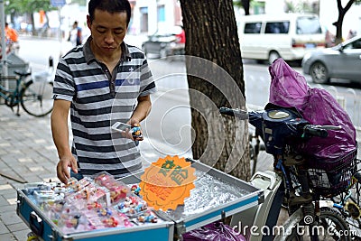 A man selling arts and crafts in the streets of Beijing Editorial Stock Photo