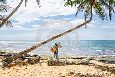 A man selling coconuts and pineapples on the beach, Hikkaduwa, Sri Lank Stock Photo
