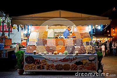 Man selling dried fruits in the old medina of Marrakech city. Marrakesh, Morocco - April 29, 2016 Editorial Stock Photo