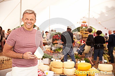 Man Selling Fresh Cheese At Farmers Food Market Stock Photo