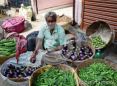 A man selling fresh vegetables at market in Delhi, India Editorial Stock Photo