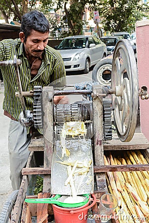 Man selling sugarcane juice Editorial Stock Photo