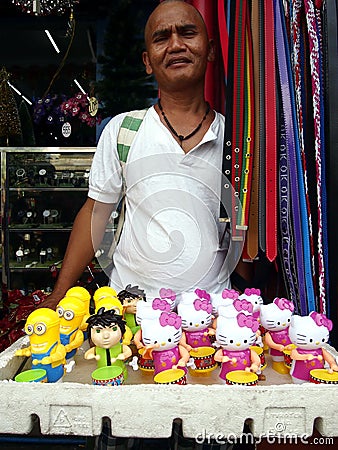 A man sells different kind of toys at a sidewalk Editorial Stock Photo