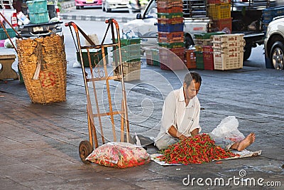 man sells fresh chili at at the street in chinatown of Bangkok Editorial Stock Photo