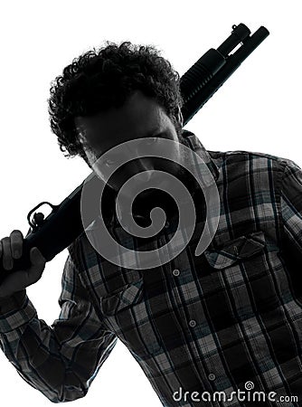 Man serial killer with shotgun silhouette portrait Stock Photo