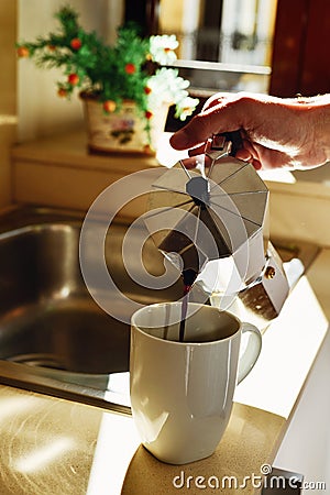 Man serving coffee from a moka pot Stock Photo