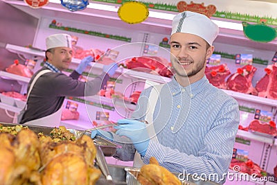 Man serving cooked chickens Stock Photo