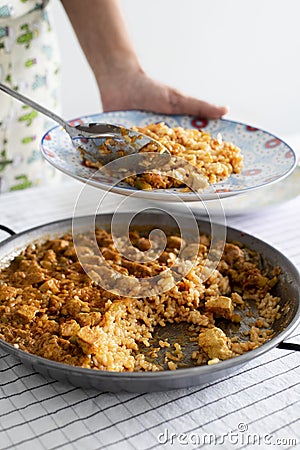 Man serving a spanish chicken paella Stock Photo