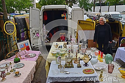 Man setting up antique stalls from van vehicle at Vanves flea market on early Saturday morning in Paris, France Editorial Stock Photo