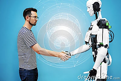 A man shakes hands with a robot close-up. engineer to create a robot. future robotics concept Stock Photo