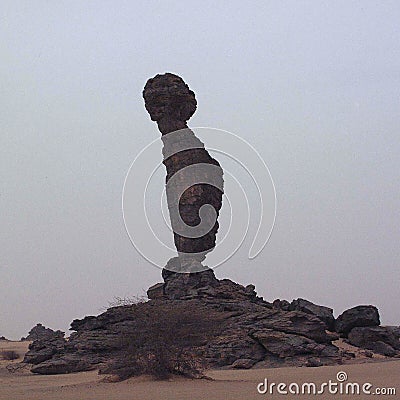 Man shaped rock in sahara desert Stock Photo