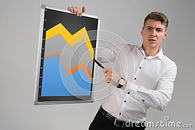 Young man holding a magnetic Board with a graph isolated on a light background Stock Photo