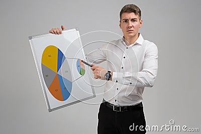 Young man holding a poster with a diagram isolated on a light background Stock Photo