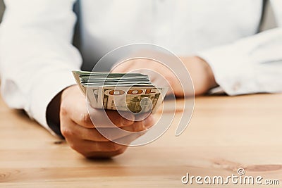 Man in shirt giving of money. Loan, finance, salary, bribe and donate concept. Stock Photo