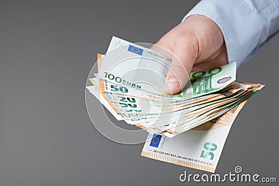 Man in shirt holding euro money in his hands. Banking, salary and donate concept. Stock Photo