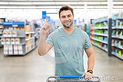 Man shopper with shopping cart. Shop idea. Impulse purchases. Random purchase. Man purchases made without a specific Stock Photo