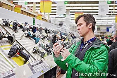 Man shopping for screwdriver in hardware store Stock Photo