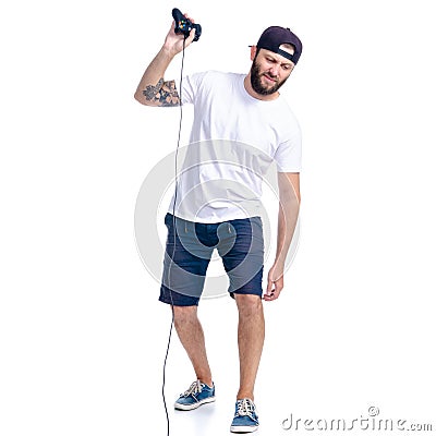 Man in shorts and cap with gamepad in hand Stock Photo